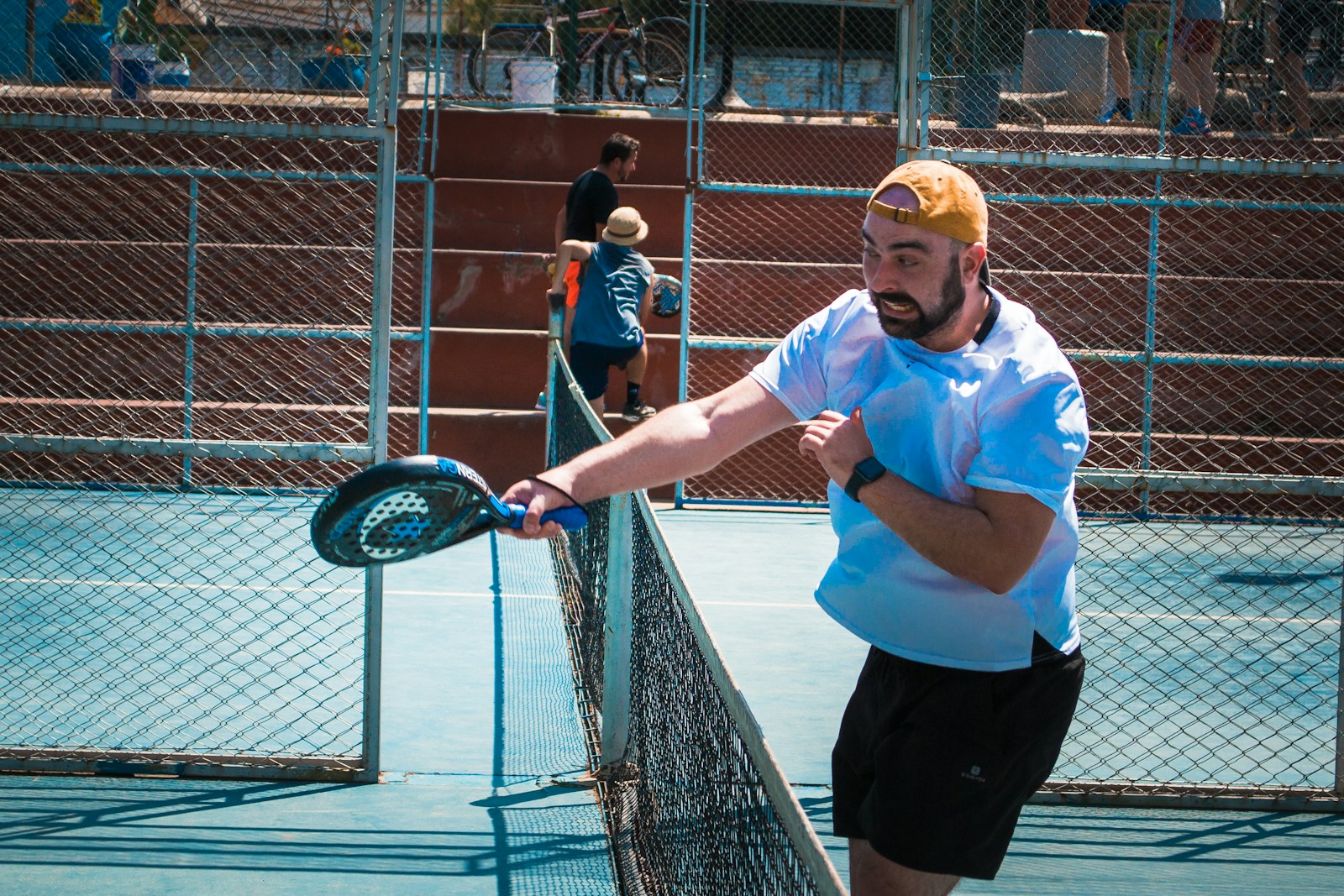 a man holding a tennis racquet on top of a tennis court